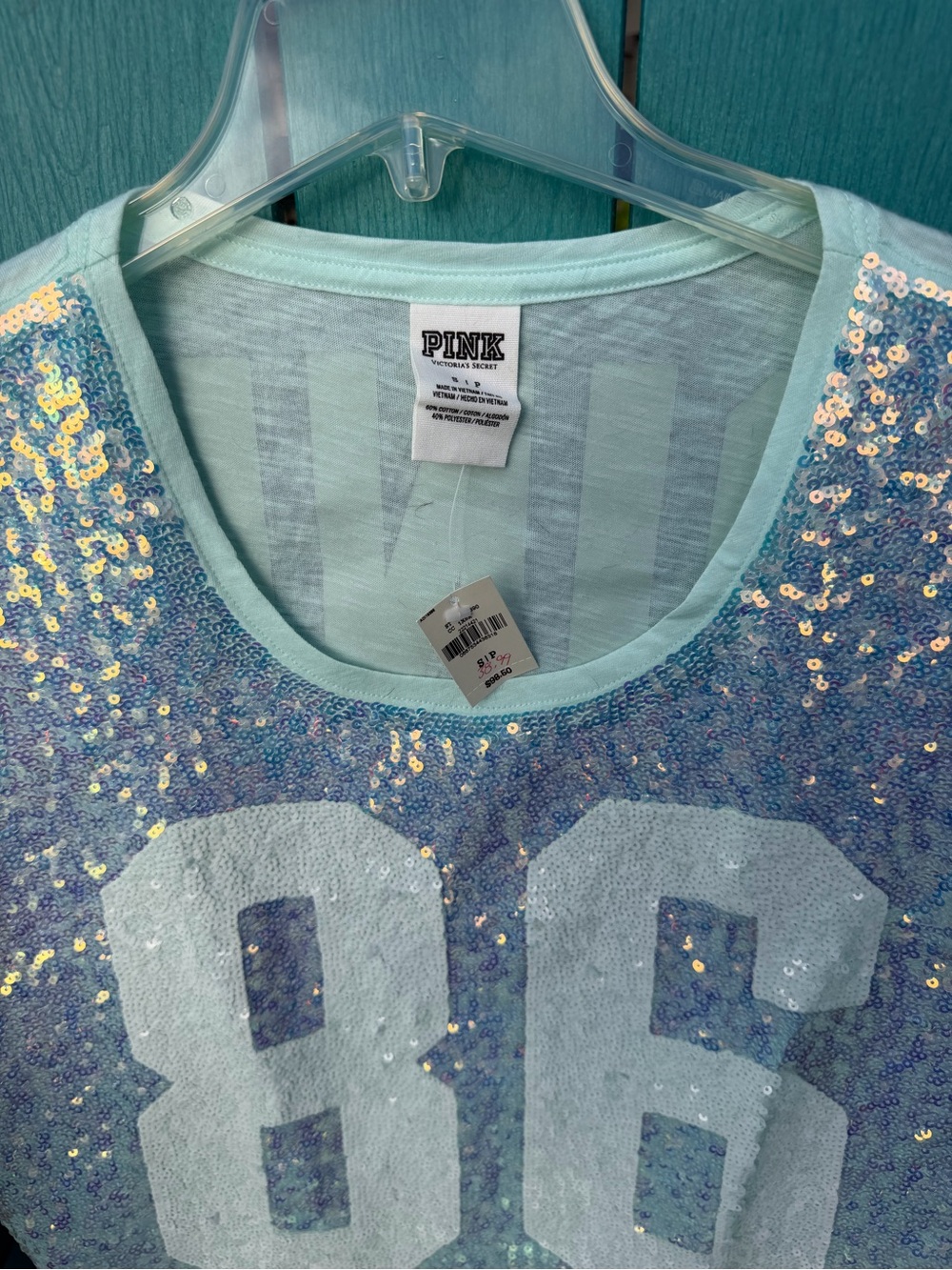 Victoria's Secret PINK light blue sequin crop top with large number '86' graphic